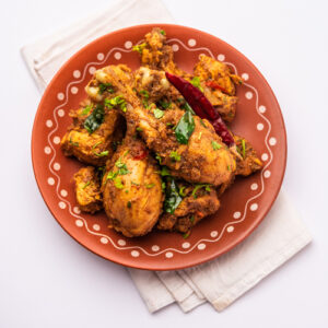 Sukha mutton or chicken, dry spicy Murgh or goat meat served in a plate or bowl